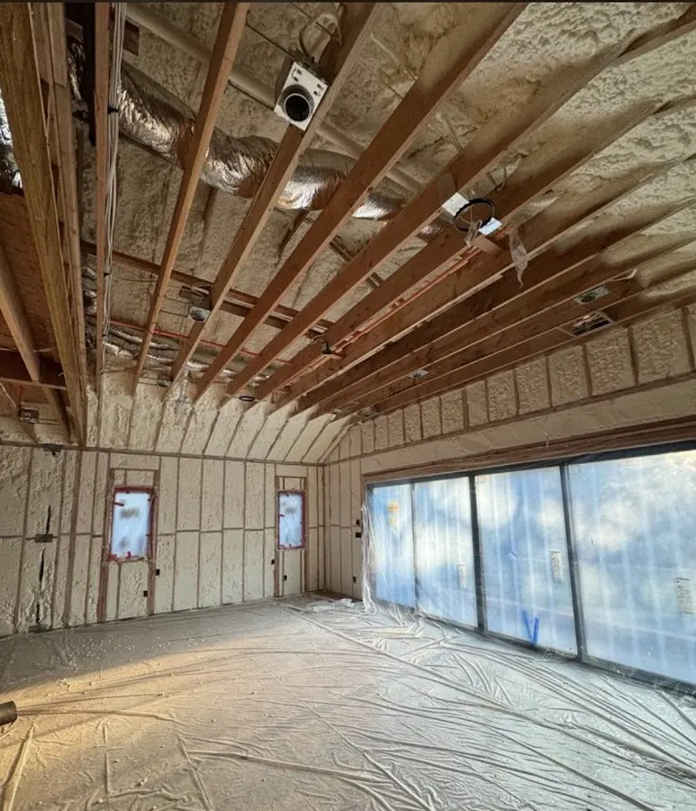 Interior walls and ceiling insulated with spray foam during new construction in Woodlawn